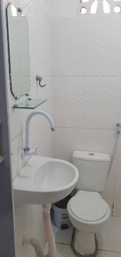 a bathroom with a white toilet and a sink at Flatstom in Parnaíba