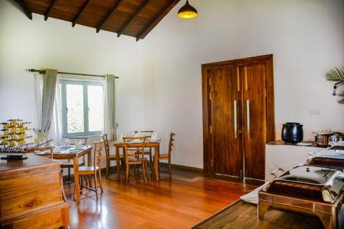 a living room with a table and a dining room at Grand Argyle Resort in Hatton