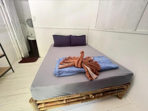 a bed in a room with a rope on it at Haad Chao Phao Resort in Haad Chao Phao