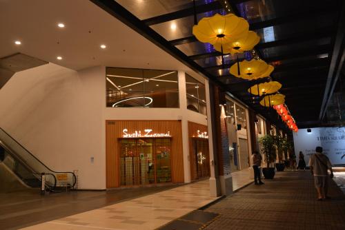 a shopping mall with lights hanging from the ceiling at My Daily Homestay - Miri Times Square in Miri