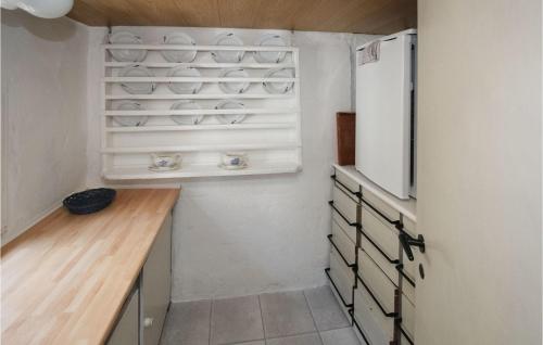 een keuken met een witte koelkast en een houten aanrecht bij 2 Bedroom Awesome Home In Sams in Toftebjerg