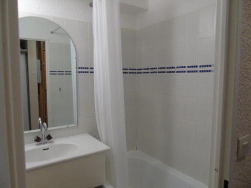 une salle de bain avec une baignoire, un lavabo et un miroir dans l'établissement Charmant studio rénové, proche télécabine, balcon sud, animaux acceptés, draps inclus, casier à ski - FR-1-561-52, à Valfréjus
