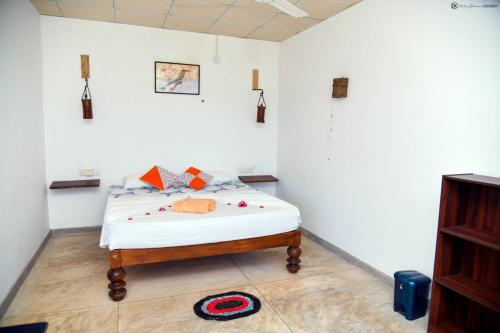 ein Schlafzimmer mit einem Bett in einem weißen Zimmer in der Unterkunft ohm lagoon home in Tangalle