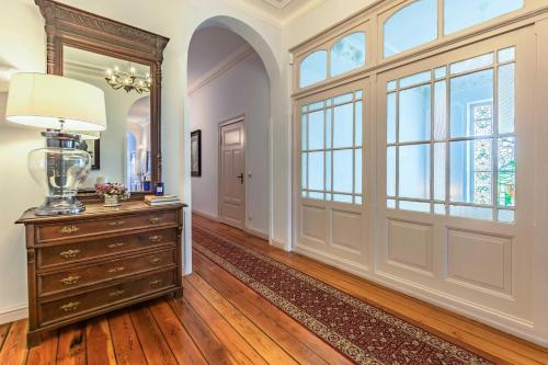 a room with a dresser and a large window at Schlosshotel Gross Koethel in Hohen Demzin