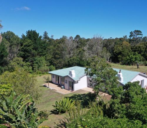 an aerial view of a white house with a blue roof at Forest Gate Estate in Plettenberg Bay
