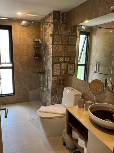 a bathroom with a toilet and a sink and a shower at Seaside vacation in Rawai Beach