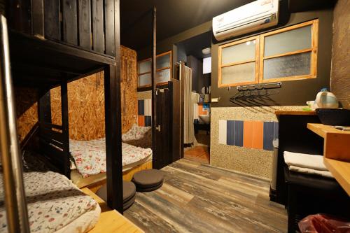 a room with two bunk beds in a house at Sha Feng Lu Dian in Magong