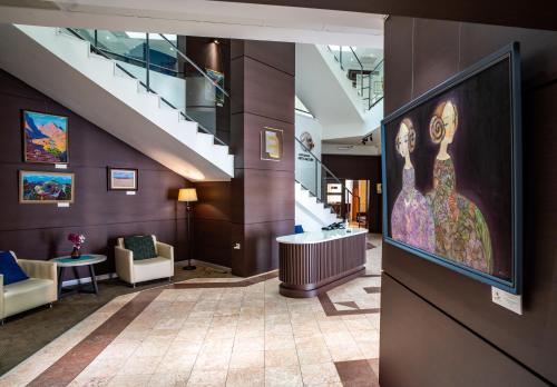 a lobby with a large painting of a woman on the wall at Edelweiss Art Hotel in Ulaanbaatar