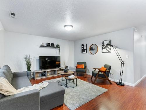 a living room with a couch and a tv at No Place Like Home in Vancouver