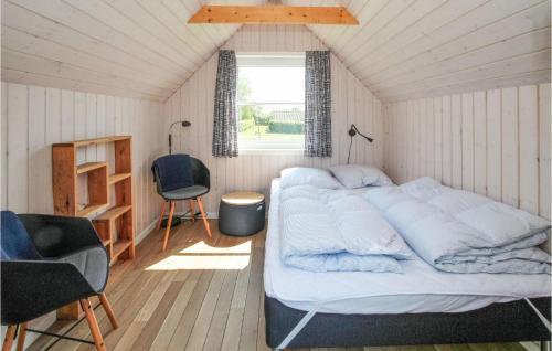 a bedroom with a large bed and a window at Gorgeous Home In Samsø With Kitchen in Onsbjerg