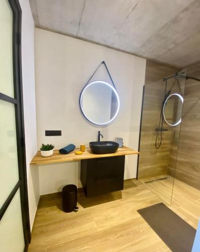 a bathroom with a sink and a mirror at Le Moulin de la Piérie in Neufchâteau
