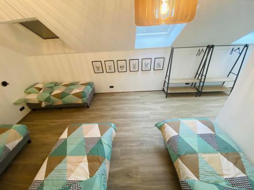 a attic room with two beds and a couch at Le Moulin de la Piérie in Neufchâteau