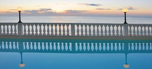 a balcony with a view of the ocean with two lights at Hotel Brigantino Non Dista in Porto Recanati