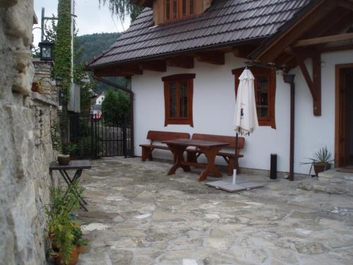 an outdoor patio with a table and an umbrella at Penzion v Podhradí in Štramberk