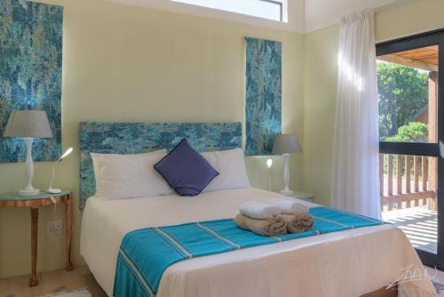 a bedroom with a bed with a teddy bear on it at No 9 Kammabaai in Eersterivier