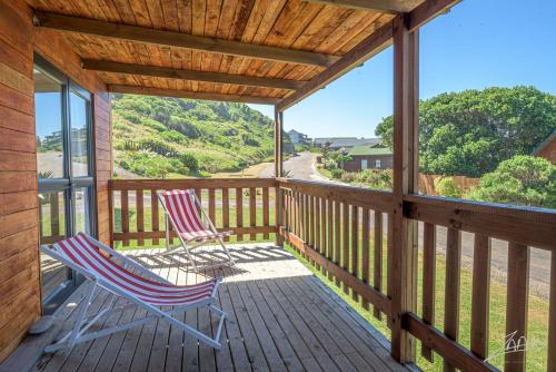 two chairs on the porch of a cabin with a view at No 9 Kammabaai in Eersterivier