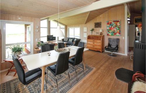 a dining room and living room with a table and chairs at Stunning Home In Samsø With Wifi in Onsbjerg