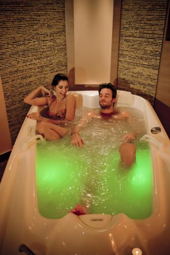 a man and woman sitting in a bath tub at Aquaworld Resort Budapest in Budapest