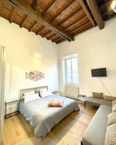 a bedroom with a large bed and a tv at Aphrodite Apartment Piazza Venezia in Rome