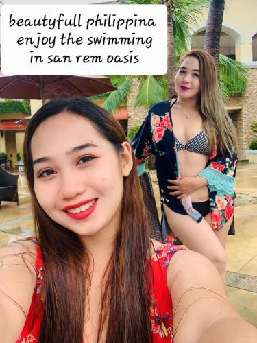two young women are posing for a picture at Two-Bedroom at San Remo Oasis in Cebu City