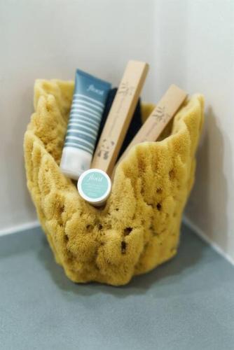 a pouch with toothbrushes and other items in it at Tiki Tiki - Gorgeous Boho Beach Hideaway! in Wailea