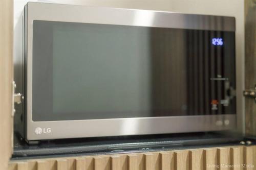 a microwave oven sitting on top of a shelf at Tiki Tiki - Gorgeous Boho Beach Hideaway! in Wailea