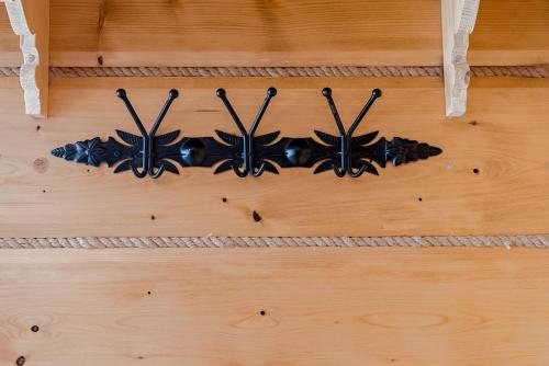 a group of black butterfly decorations on a wooden floor at Osada Wichrówka in Dursztyn