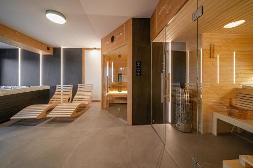 a room with chairs and a glass wall at Osada Wichrówka in Dursztyn