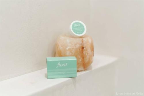 a couple of donuts sitting on a shelf with a box at Aloha Moon - A Chic and Dreamy Modern Tropical Hideaway! in Wailea
