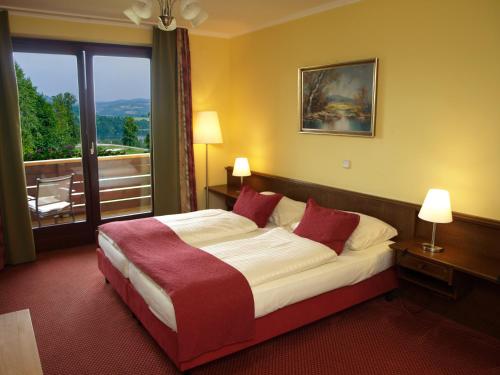 Postel nebo postele na pokoji v ubytování Hotel Fasching
