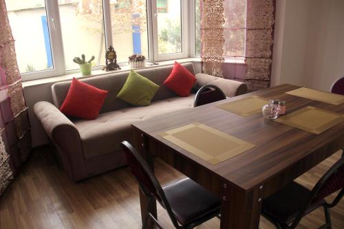 uma sala de estar com um sofá e uma mesa em Colour em Baku