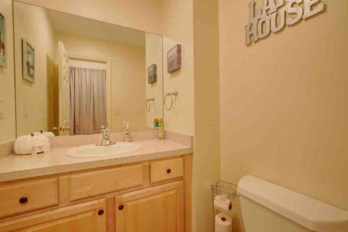 a bathroom with a sink and a mirror and a toilet at Amazing Acorn in Diamond Point