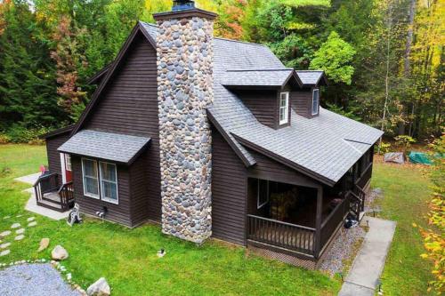 a house with a chimney on the side of it at Amazing Acorn in Diamond Point