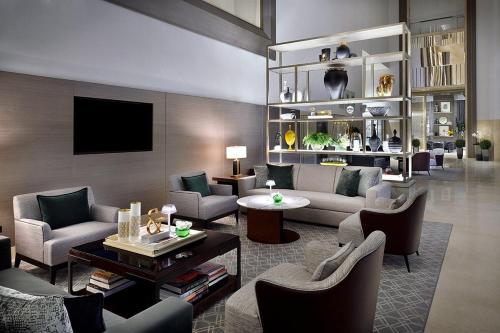 a living room with a couch and chairs and a tv at Fashion avenue-Formerly The Address Dubai Mall residence - Downtown in Dubai