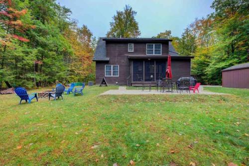 a house with chairs and tables in the yard at Amazing Acorn in Diamond Point