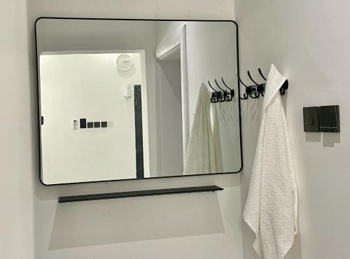 a mirror on a wall in a bathroom at شاليه الروح AlRooh Chalet in Al Raka