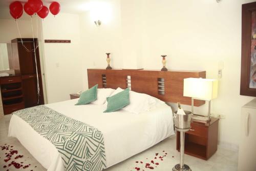 a bedroom with a bed with red balloons on it at Hotel Barrancabermeja Plaza in Barrancabermeja