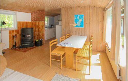 a kitchen and dining room with a table and chairs at Cozy Home In Samsø With Kitchen in Kolby Kås