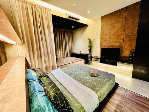 a bedroom with a large bed and a television at Montana Suites 3, Empire Damansara in Petaling Jaya
