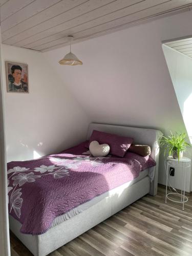 a bedroom with a purple bed with a purple blanket at City Appartment mit Gartennutzung in Bremen