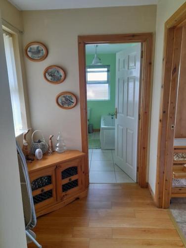 a hallway with a door open to a bathroom at THE LAKE HOUSE: a delightful and peaceful retreat. in Derrymacash