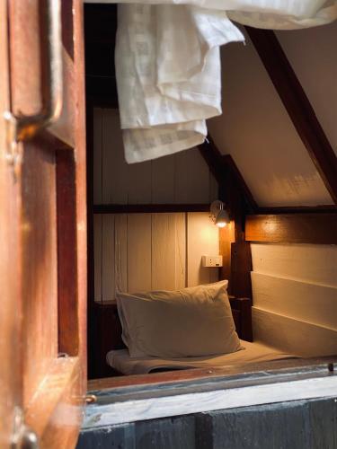 a view of a bed in a small room at Little Eden Guesthouse in Pang Mapha