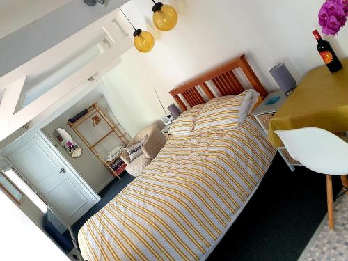 a bedroom with a large bed and a desk at Bracken's Retreat in Lostwithiel