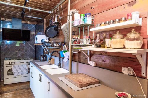 a kitchen with a sink and a counter top at Vibe Naftali Estate in Ramot Naftali
