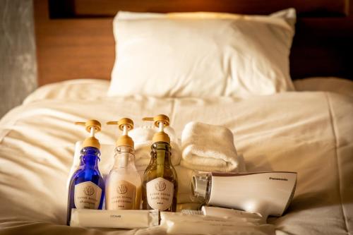 a group of bottles sitting on top of a bed at Satsuki  in Gojō