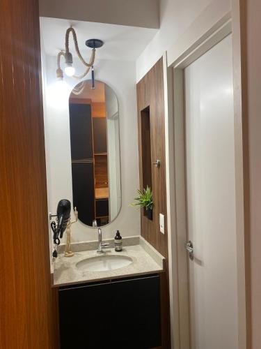 a bathroom with a sink and a mirror at São Paulo - Vila Mariana - Central in Sao Paulo