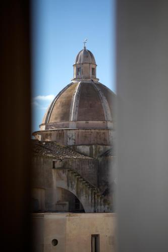 a view of a building through a window at WeLive Trapani - luxury apartments in Trapani