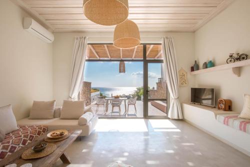a living room with a view of the ocean at Onar Beach Houses in Amoopi