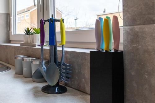 a group of utensils on a counter in a kitchen at The Eldern - Spacious, Netflix, free Parking, close to A1 in Peterborough