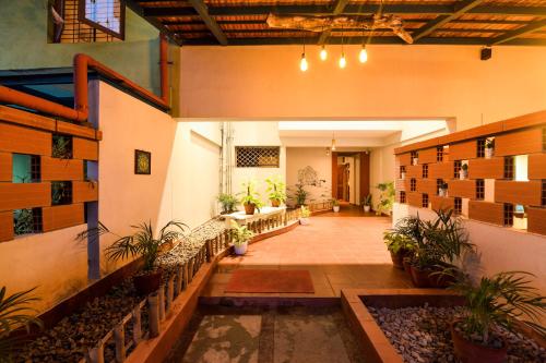 a hallway of a building with plants in it at SAFARI QUEST in Mysore